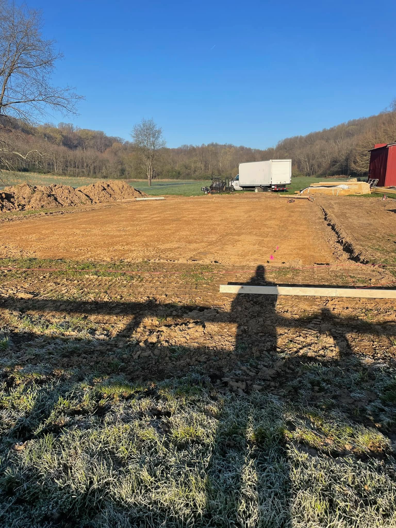 Graded and cleared building site with excavation equipment staged for a new build